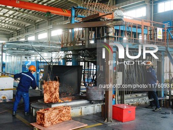 A worker of Yangfan Copper (Anhui) Co LTD works on a production line at the Yuexi County Economic Development Zone in Anqing, China, on Nove...