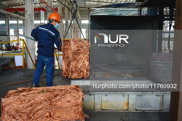 A worker of Yangfan Copper (Anhui) Co LTD works on a production line at the Yuexi County Economic Development Zone in Anqing, China, on Nove...