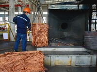 A worker of Yangfan Copper (Anhui) Co LTD works on a production line at the Yuexi County Economic Development Zone in Anqing, China, on Nove...