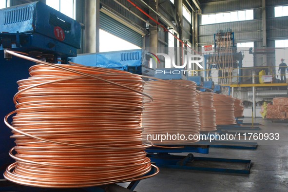 A worker of Yangfan Copper (Anhui) Co LTD works on a production line at the Yuexi County Economic Development Zone in Anqing, China, on Nove...