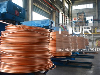 A worker of Yangfan Copper (Anhui) Co LTD works on a production line at the Yuexi County Economic Development Zone in Anqing, China, on Nove...