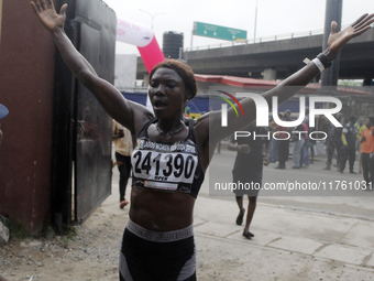 Joy Abiye David, the champion of the Lagos Women Run 2024, with an impressive time of 39:35:21, celebrates during the ninth edition of the L...