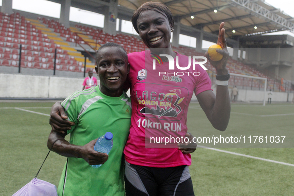 Joy Abiye David, the champion of the Lagos Women Run 2024, with an impressive time of 39:35:21 (R), is hugged during the ninth edition of th...