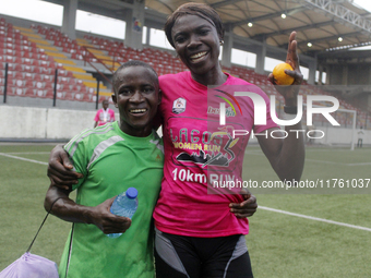 Joy Abiye David, the champion of the Lagos Women Run 2024, with an impressive time of 39:35:21 (R), is hugged during the ninth edition of th...