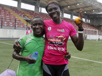 Joy Abiye David, the champion of the Lagos Women Run 2024, with an impressive time of 39:35:21 (R), is hugged during the ninth edition of th...