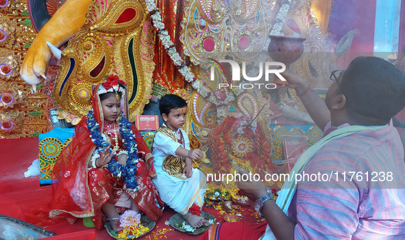 Indian children dressed as Lord Durga and Lord Shiva are worshiped during the rituals of Jagaddhatri Puja in Siliguri, India, on November 10...