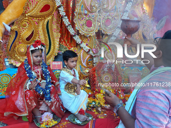 Indian children dressed as Lord Durga and Lord Shiva are worshiped during the rituals of Jagaddhatri Puja in Siliguri, India, on November 10...