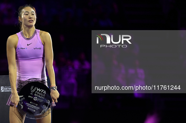 RIYADH, SAUDI ARABIA - NOVEMBER 09: Qinwen Zheng of China holds the runner-up trophy after losing to Coco Gauff of the United States in the...