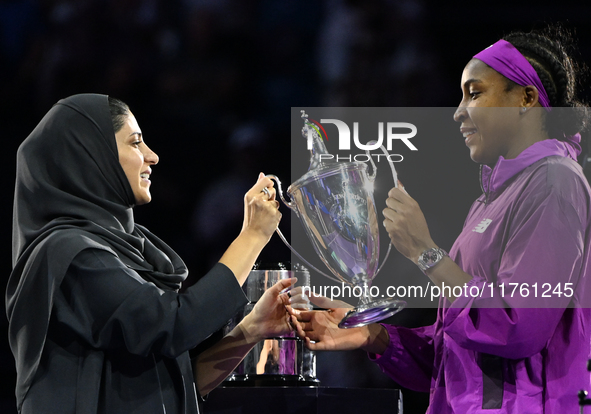 RIYADH, SAUDI ARABIA - NOVEMBER 09: Coco Gauff of the United States is presented the Billie Jean King Trophy after defeating Qinwen Zheng of...