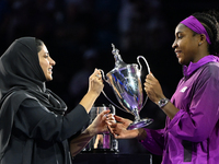 RIYADH, SAUDI ARABIA - NOVEMBER 09: Coco Gauff of the United States is presented the Billie Jean King Trophy after defeating Qinwen Zheng of...