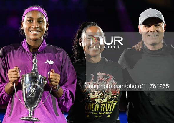 RIYADH, SAUDI ARABIA - NOVEMBER 09: Coco Gauff of the United States poses with her mother Candi Gauff and coach Matt Daly, after defeating Q...