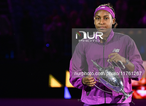 RIYADH, SAUDI ARABIA - NOVEMBER 09: Coco Gauff of the United States carries with the Billie Jean King Trophy after defeating Qinwen Zheng of...