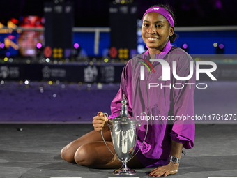 RIYADH, SAUDI ARABIA - NOVEMBER 09: Coco Gauff of the United States poses with the Billie Jean King Trophy after defeating Qinwen Zheng of C...