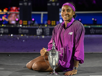 RIYADH, SAUDI ARABIA - NOVEMBER 09: Coco Gauff of the United States poses with the Billie Jean King Trophy after defeating Qinwen Zheng of C...