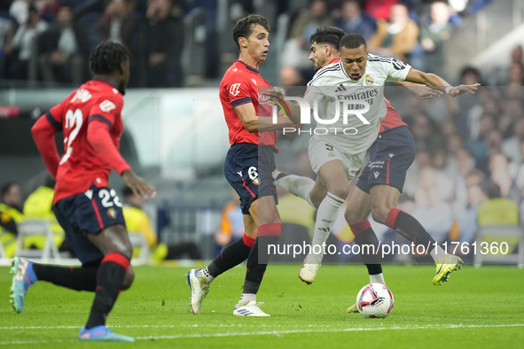 Kylian Mbappe centre-forward of Real Madrid and France surrounded by Oasuna's players during the La Liga match between Real Madrid CF and CA...