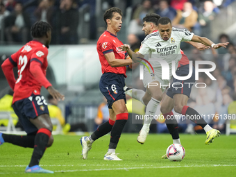 Kylian Mbappe centre-forward of Real Madrid and France surrounded by Oasuna's players during the La Liga match between Real Madrid CF and CA...