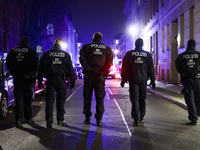 German policemen are protecting a march commemorating the 65th anniversary of the Night of Broken Glass (Kristallnacht) in Berlin, Germany o...