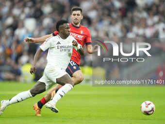 Vinicius Junior left winger of Real Madrid and Brazil and Jesus Areso right-back of Osasuna and Spain compete for the ball during the La Lig...