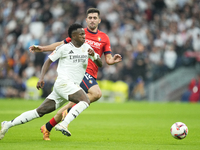 Vinicius Junior left winger of Real Madrid and Brazil and Jesus Areso right-back of Osasuna and Spain compete for the ball during the La Lig...