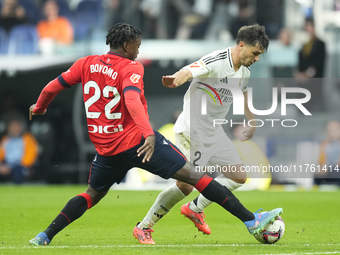 Brahim Diaz attacking midfield of Real Madrid and Spain and Enzo Boyomo centre-back of Osasuna and Cameroon compete for the ball during the...