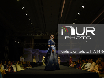 A city industrialist in Indian traditional dress walks the runway during a fashion show organized by Lions International at JW Marriott in K...