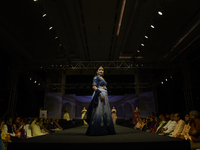 A city industrialist in Indian traditional dress walks the runway during a fashion show organized by Lions International at JW Marriott in K...