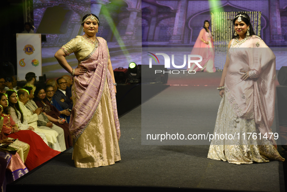 A city industrialist in Indian traditional dress walks the runway during a fashion show organized by Lions International at JW Marriott in K...