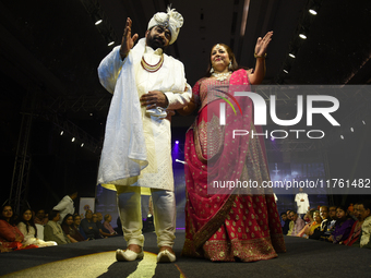 A city industrialist in Indian traditional dress walks the runway during a fashion show organized by Lions International at JW Marriott in K...