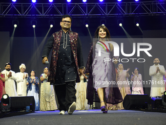 Fashion designers Vandana Gupta and Pankaj Kumar, fashion designer Tejas Gandhi, and model Madhabilata Mitra participate in a fashion show o...