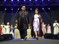 Fashion designers Vandana Gupta and Pankaj Kumar, fashion designer Tejas Gandhi, and model Madhabilata Mitra participate in a fashion show o...