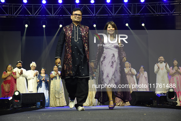 Fashion designers Vandana Gupta and Pankaj Kumar, fashion designer Tejas Gandhi, and model Madhabilata Mitra participate in a fashion show o...