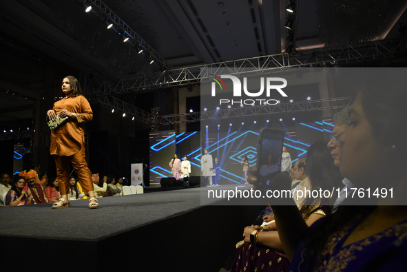 A city industrialist in Indian traditional dress walks the runway during a fashion show organized by Lions International at JW Marriott in K...