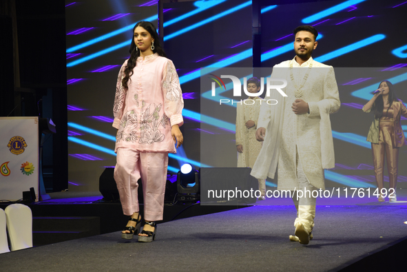 A city industrialist in Indian traditional dress walks the runway during a fashion show organized by Lions International at JW Marriott in K...