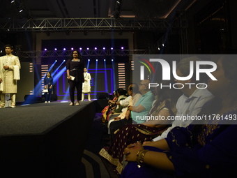 A city industrialist in Indian traditional dress walks the runway during a fashion show organized by Lions International at JW Marriott in K...