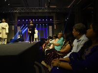 A city industrialist in Indian traditional dress walks the runway during a fashion show organized by Lions International at JW Marriott in K...