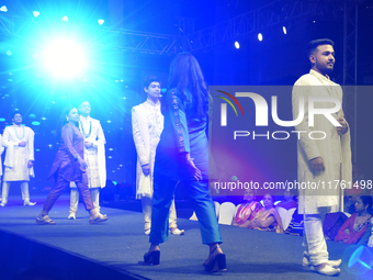 A city industrialist in Indian traditional dress walks the runway during a fashion show organized by Lions International at JW Marriott in K...