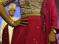 A city industrialist in Indian traditional dress walks the runway during a fashion show organized by Lions International at JW Marriott in K...