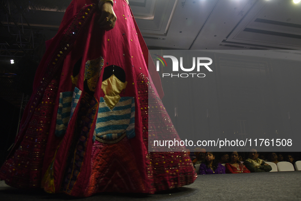 A city industrialist in Indian traditional dress walks the runway during a fashion show organized by Lions International at JW Marriott in K...