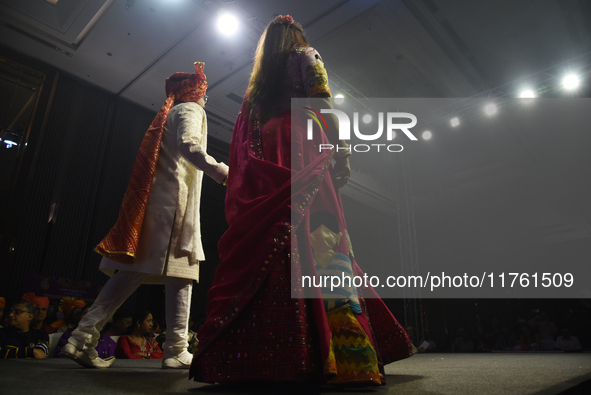 A city industrialist in Indian traditional dress walks the runway during a fashion show organized by Lions International at JW Marriott in K...