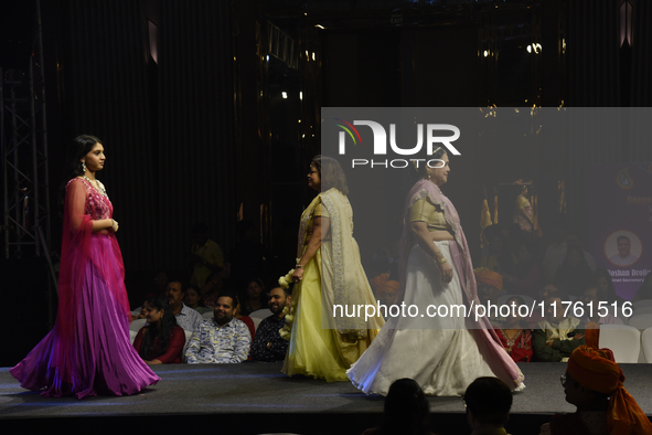 A city industrialist in Indian traditional dress walks the runway during a fashion show organized by Lions International at JW Marriott in K...