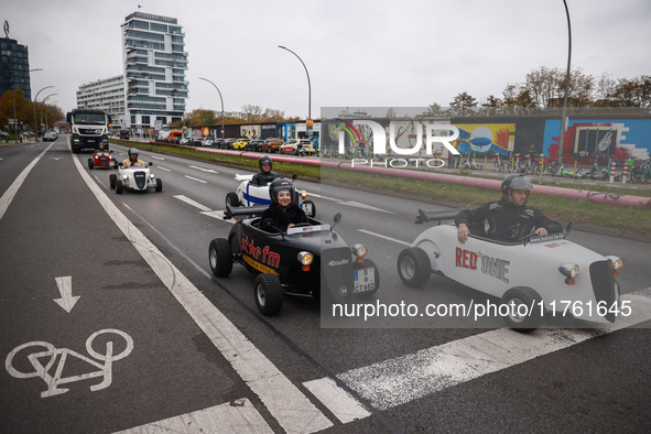 Mini hotcrod city tour cars are seen by East Side Gallery in Berlin, Germany on November 8th, 2024. 