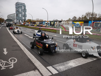 Mini hotcrod city tour cars are seen by East Side Gallery in Berlin, Germany on November 8th, 2024. (