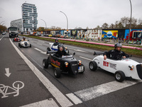 Mini hotcrod city tour cars are seen by East Side Gallery in Berlin, Germany on November 8th, 2024. (