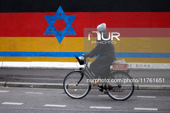 A mix of German and Israeli flags on the East Side Gallery in Berlin, Germany on November 8th, 2024. 