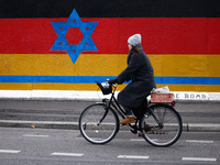 A mix of German and Israeli flags on the East Side Gallery in Berlin, Germany on November 8th, 2024. (