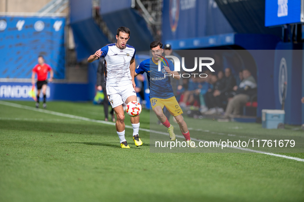 Luismi Redondo of FC Andorra and Iker Pedernales of Barakaldo CF are in action during the Primera RFEF 2024-2025 match between FC Andorra an...