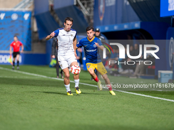 Luismi Redondo of FC Andorra and Iker Pedernales of Barakaldo CF are in action during the Primera RFEF 2024-2025 match between FC Andorra an...