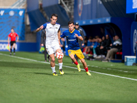 Luismi Redondo of FC Andorra and Iker Pedernales of Barakaldo CF are in action during the Primera RFEF 2024-2025 match between FC Andorra an...