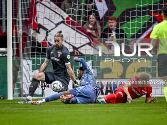 FC Twente goalkeeper Lars Unnerstall and AFC Ajax Amsterdam forward Chuba Akpom participate in the match between Twente and Ajax at the Grol...