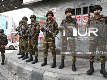 Bangladesh army soldiers stand guard at an intersection in the Mirpur area during an anti-discrimination student movement determined to foil...